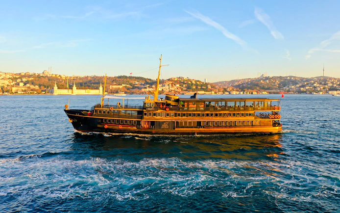 Le Vapeur Magique cruising on the Bosphorus with Istanbul skyline in the background.