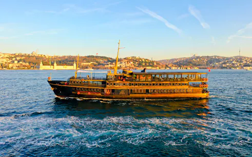 Le Vapeur Magique cruising on the Bosphorus with Istanbul skyline in the background.