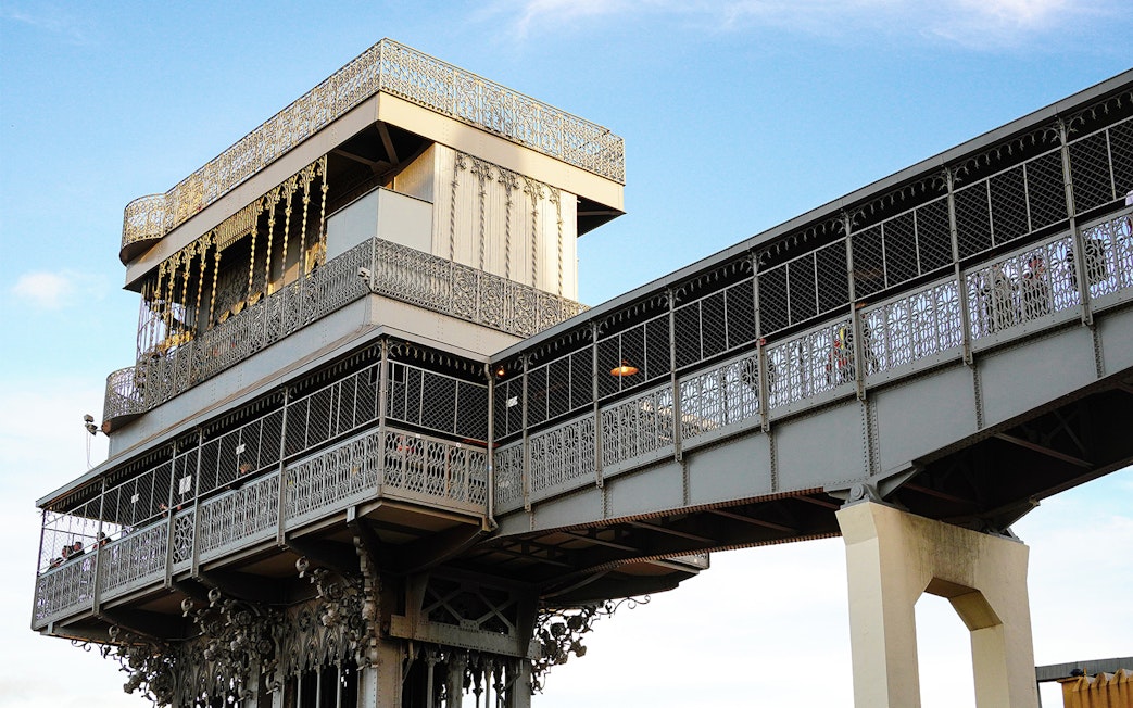 Santa Justa Lift in Lisbon, Portugal, with intricate ironwork against a blue sky.