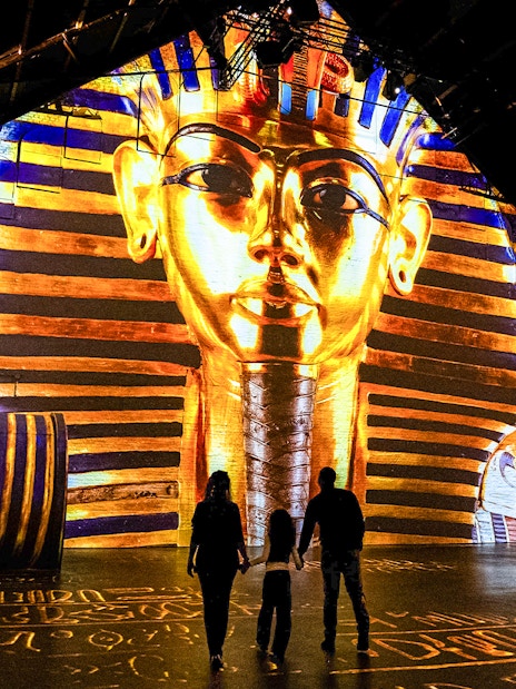 Visitors at Fabrique des Lumières viewing Pharaoh projection exhibit.