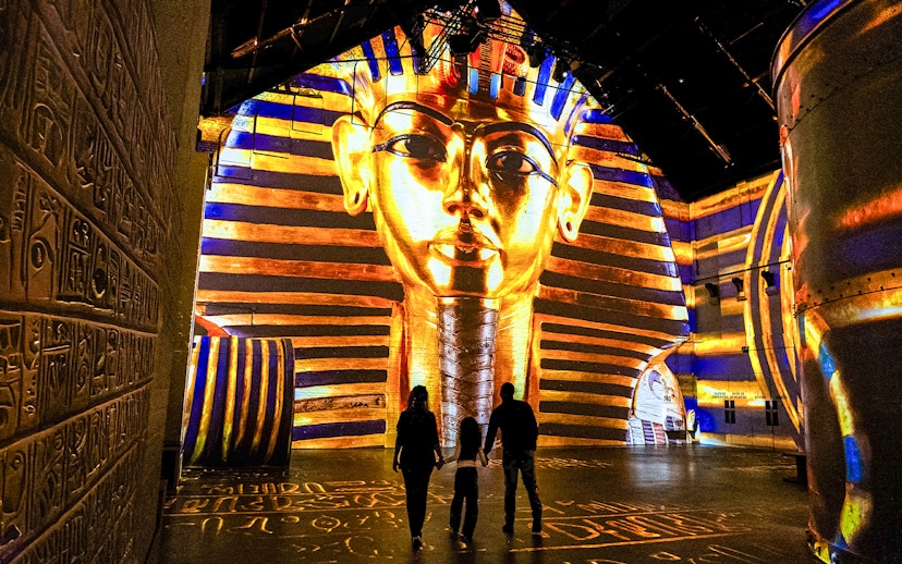 Visitors at Fabrique des Lumières viewing Pharaoh projection exhibit.