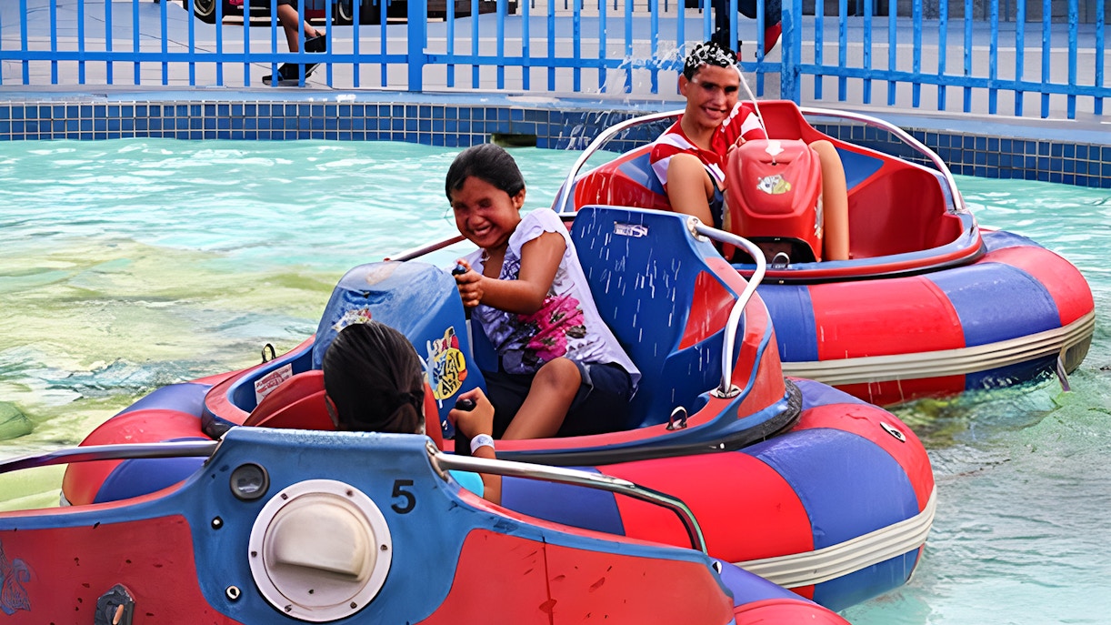 Kids enjoying bumper boats at Fun Spot America Theme Park, Orlando.