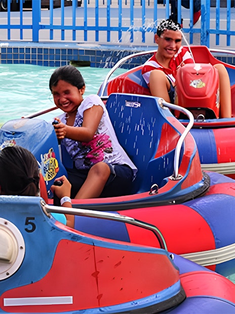 Kids enjoying bumper boats at Fun Spot America Theme Park, Orlando.