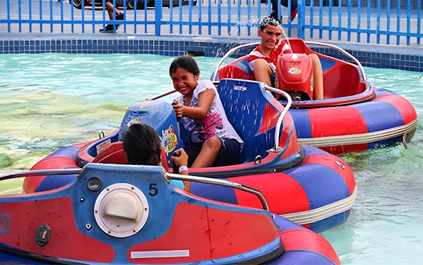 Kids enjoying bumper boats at Fun Spot America Theme Park, Orlando.