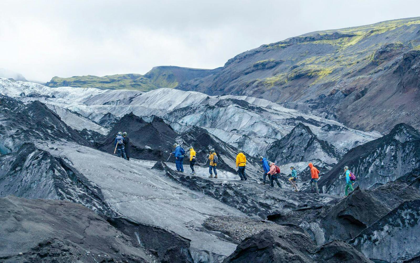 Hikers exploring Sólheimajökull glacier in Iceland.