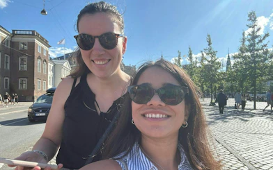 Two people enjoying a sunny day in Copenhagen during a self-guided city exploration game.