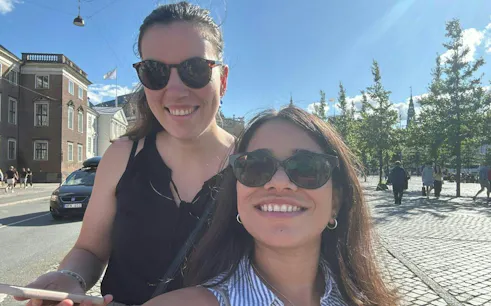 Two people enjoying a sunny day in Copenhagen during a self-guided city exploration game.