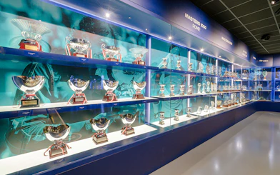 Trophy display at Rafa Nadal Museum showcasing tennis achievements.