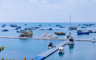 Boats anchored near a pier in the waters off Phu Quoc Island, Vietnam.