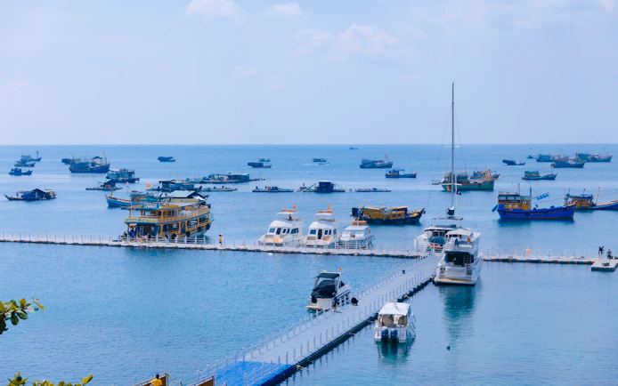 Boats anchored near a pier in the waters off Phu Quoc Island, Vietnam.