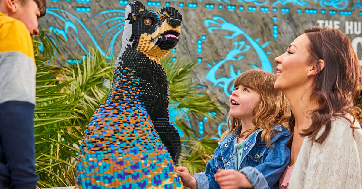 Guests admiring a colorful Lego bear sculpture at Legoland Windsor.