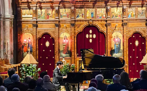Pianist performing at Chopin Piano Concert in Saint-Julien-le-Pauvre, Paris.