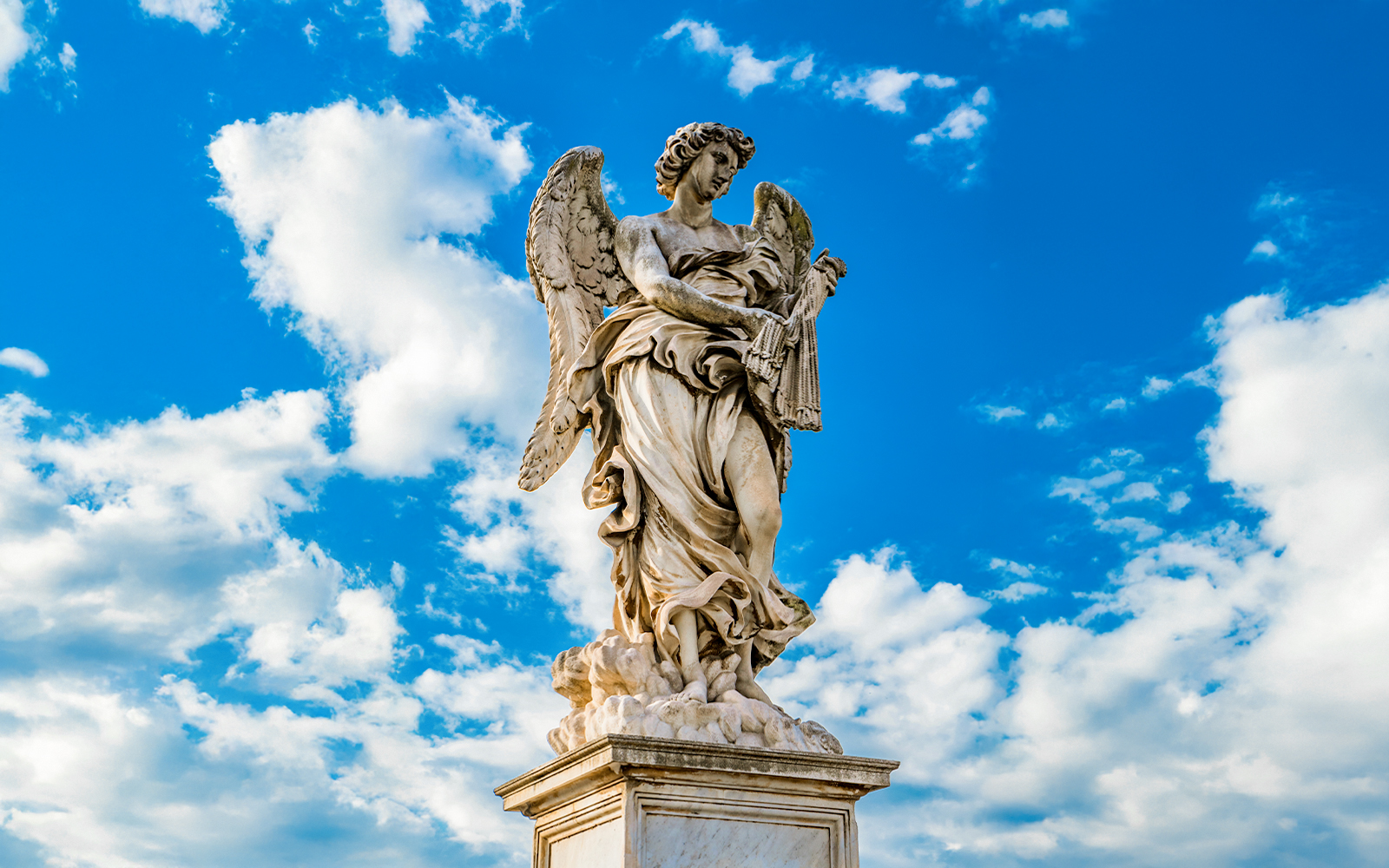 Angel statue holding scourges on Ponte Sant'Angelo bridge, Rome, Italy.