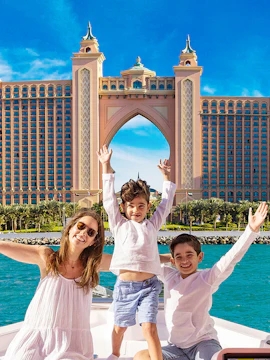 Family enjoying a boat ride near Atlantis, The Palm in Dubai during winter break specials.