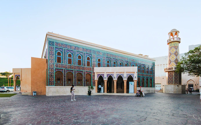 Katara Mosque with intricate tile facade and minaret in Katara Village, Qatar.