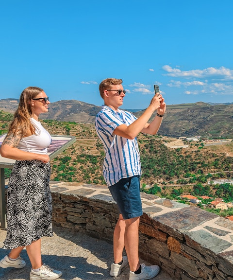 Tourists photographing Douro Valley landscape, Portugal.