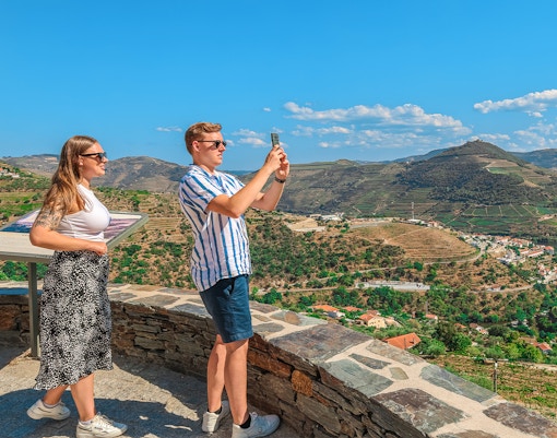 Tourists photographing Douro Valley landscape, Portugal.