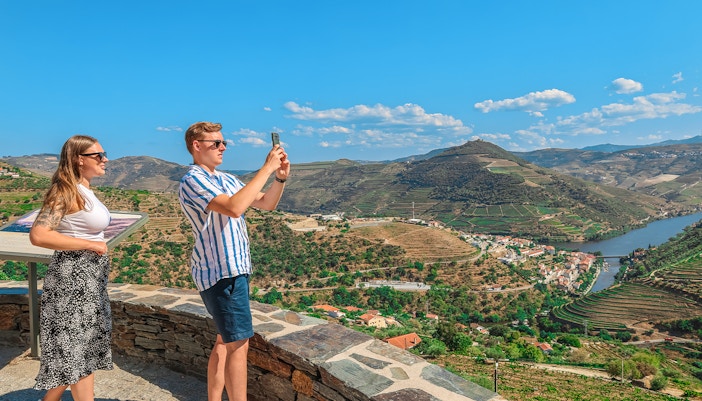 Tourists photographing Douro Valley landscape, Portugal.