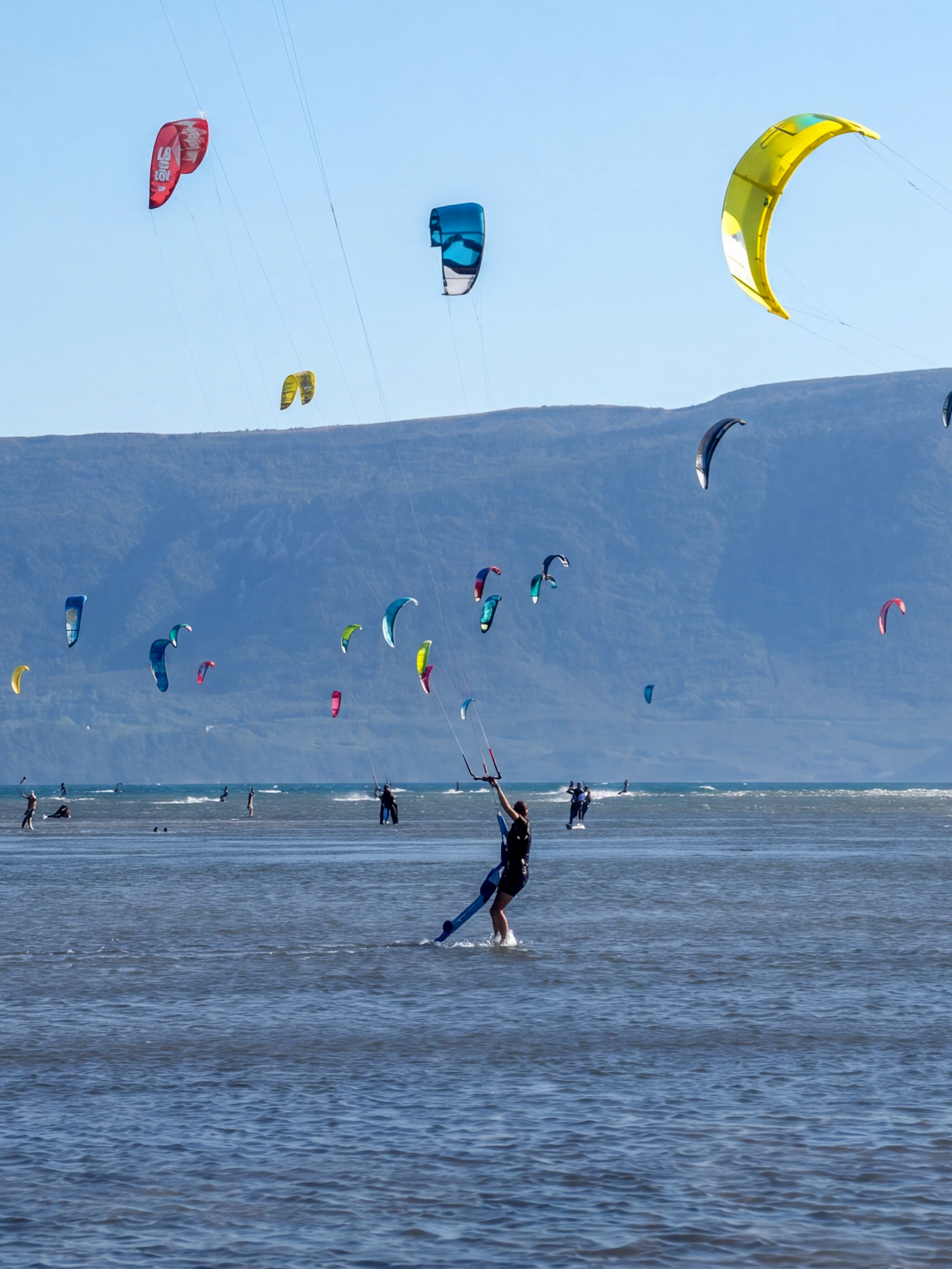 Kiteboarders on the water with colorful kites at Delta Neretva, Croatia.