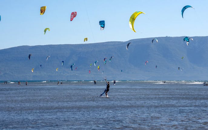 Kiteboarders on the water with colorful kites at Delta Neretva, Croatia.