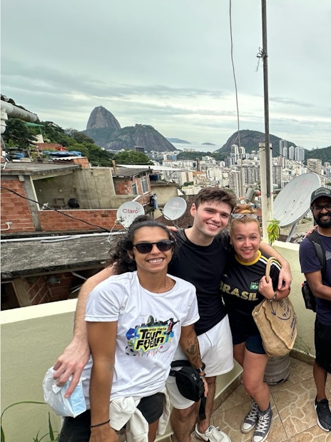 Tourists with guide at a viewpoint overlooking Santa Marta, Rio de Janeiro.