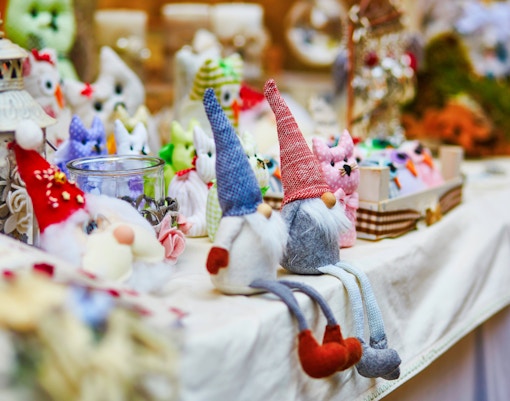 Handcrafted gnome dolls displayed at a market stall in San Diego's Little Italy.