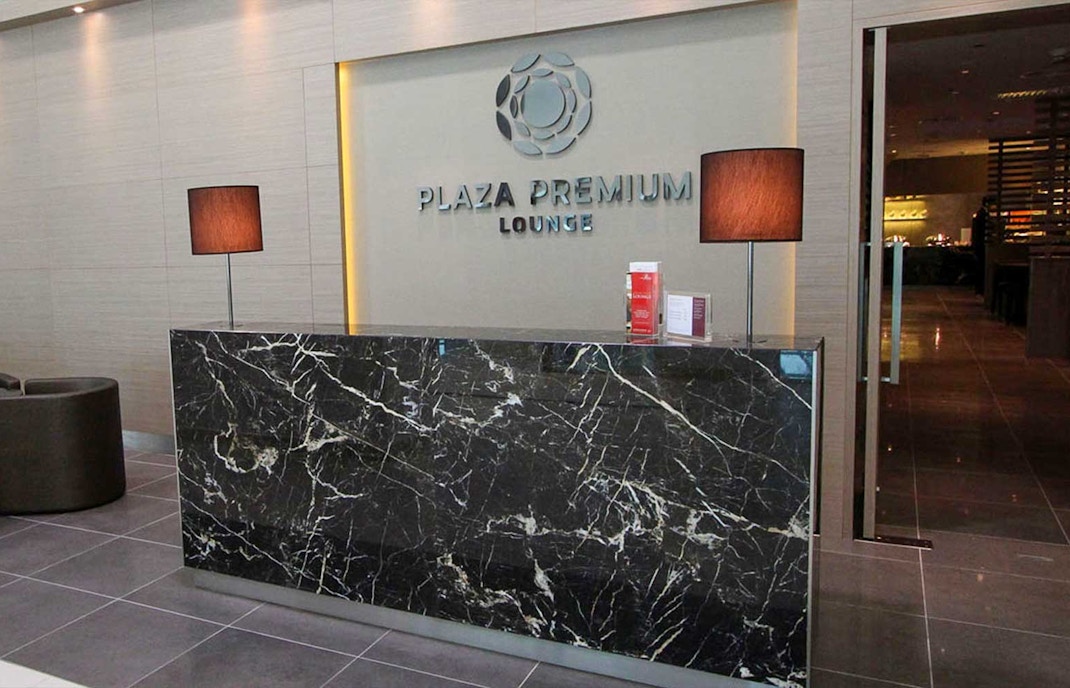 Plaza Premium Lounge seating area with travelers in Penang International Airport, Malaysia.
