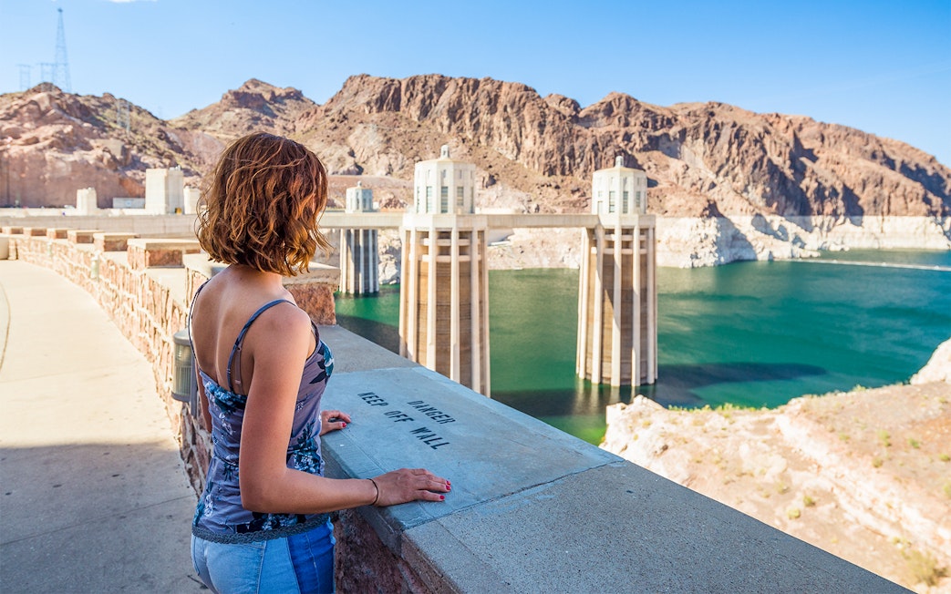Visitor overlooking Hoover Dam reservoir during exploration tour.