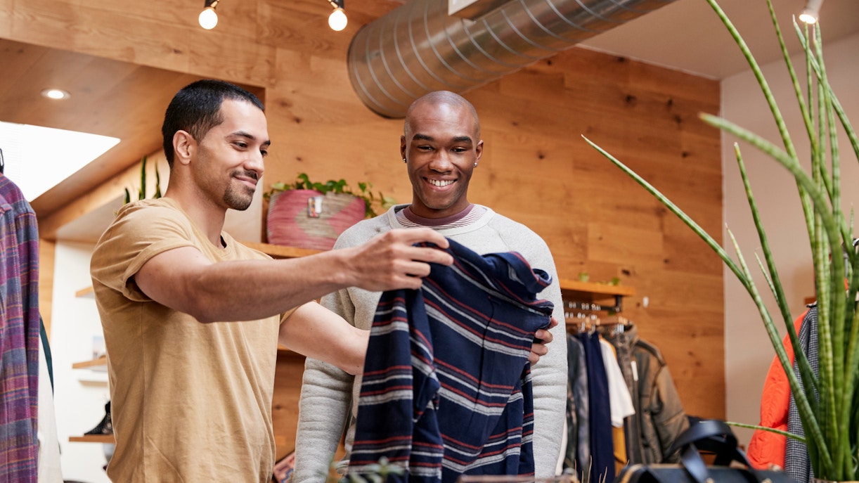 Men browsing clothing.