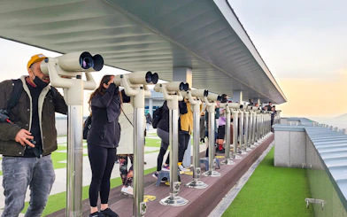 Tourists using binoculars at Dorasan Observatory in South Korea.