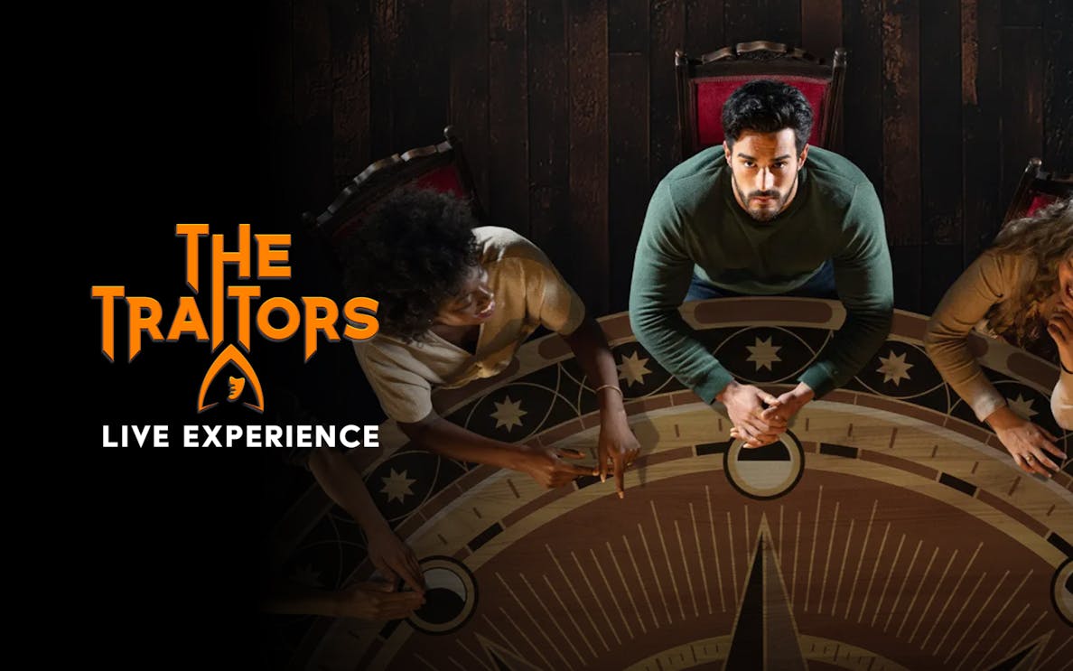 Participants gathered around a circular table for The Traitors Live Experience.