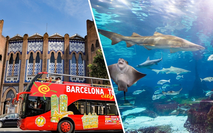 Barcelona tour bus in front of historic building and aquarium with sharks and rays.