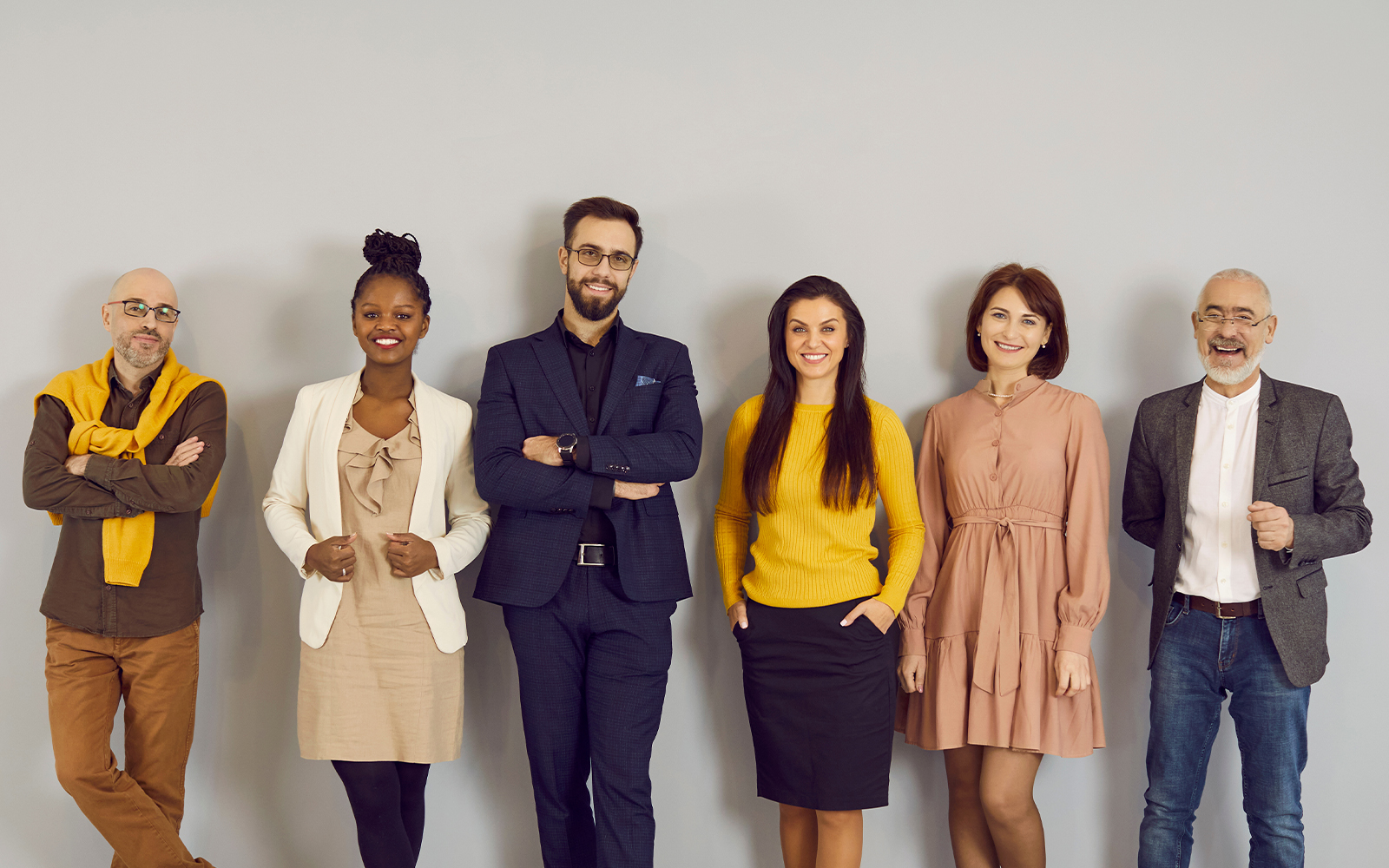  five people standing in a line, wearing semi-formals