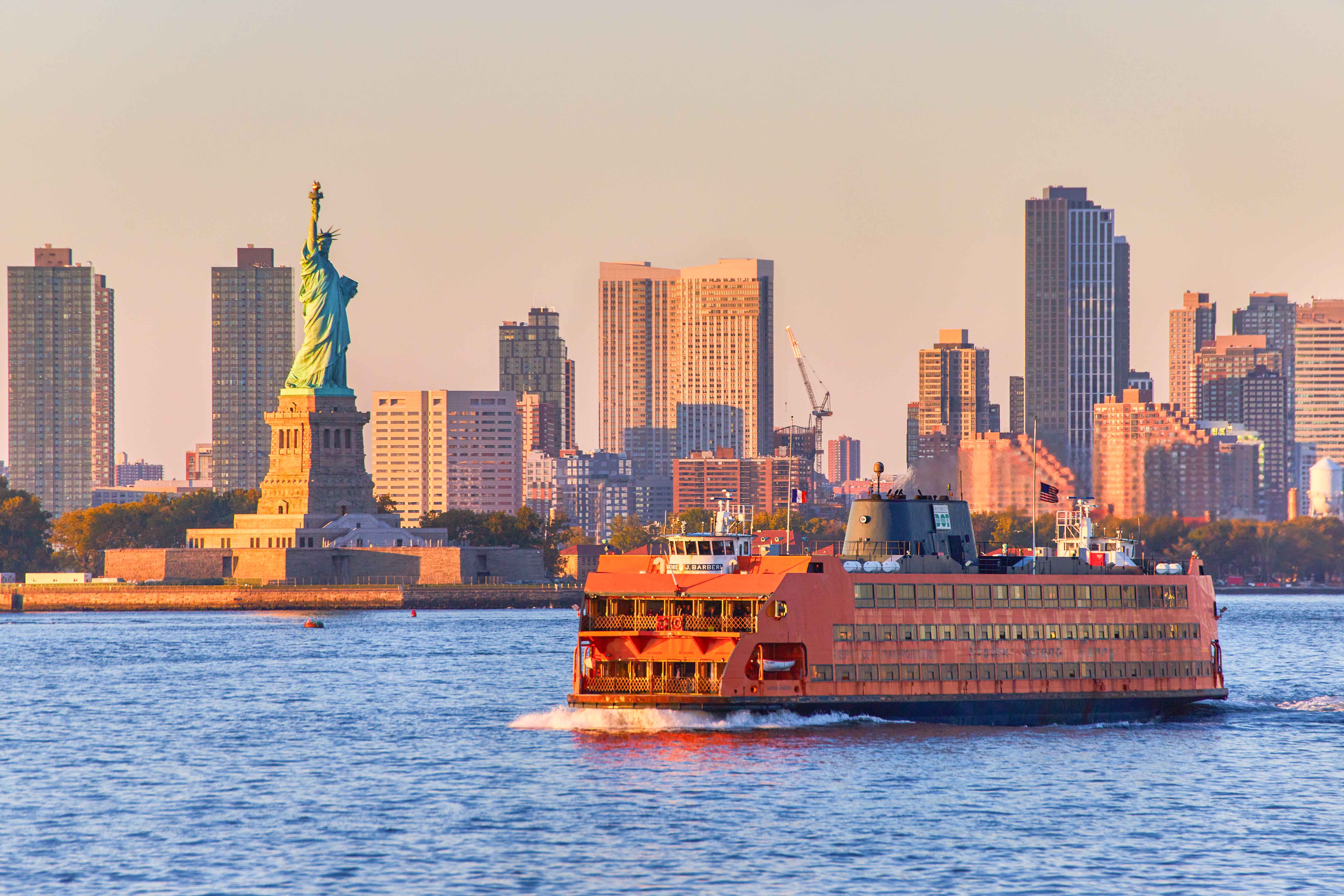Staten Island Ferry with Statue of Liberty and Manhattan skyline in the background.