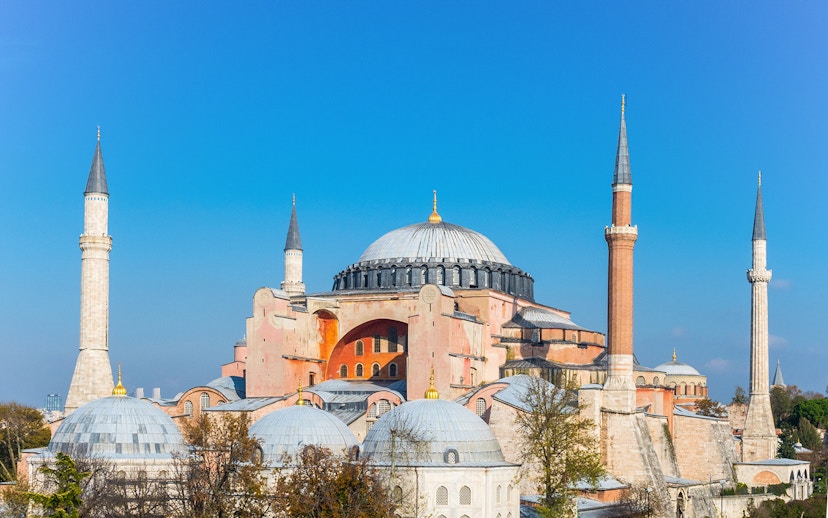 Hagia Sophia with minarets under clear blue sky in Istanbul.