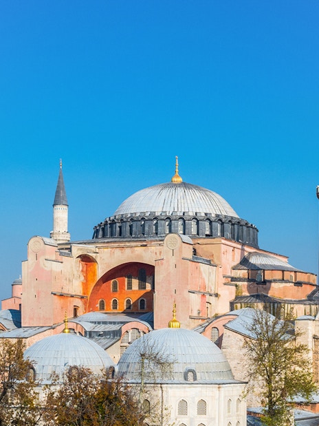 Hagia Sophia with minarets under clear blue sky in Istanbul.