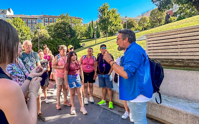 Tour guide speaking to a group outside the Prado Museum in Madrid.