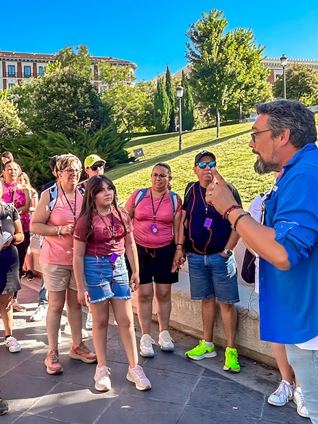 Tour guide speaking to a group outside the Prado Museum in Madrid.
