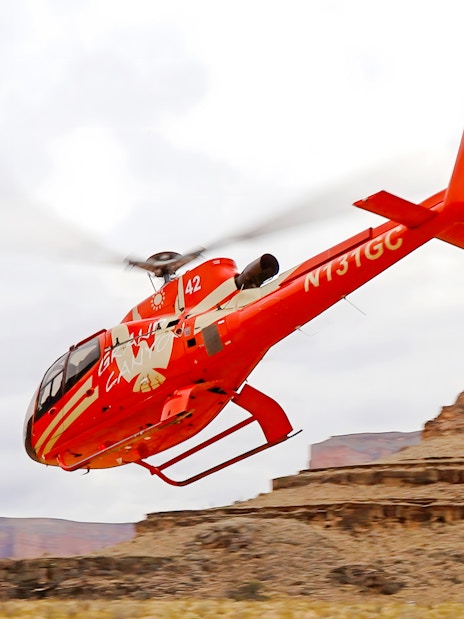 Helicopter flying over Grand Canyon West Rim during tour with floor landing and boat ride.