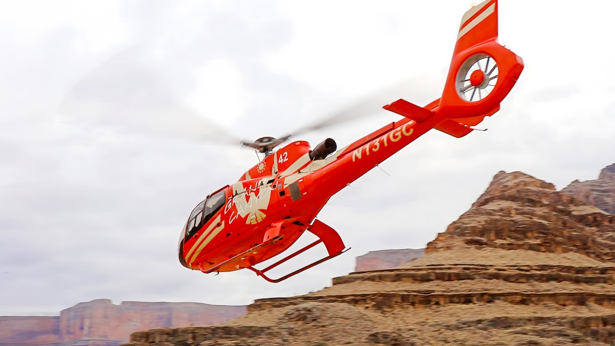 Helicopter flying over Grand Canyon West Rim during tour with floor landing and boat ride.