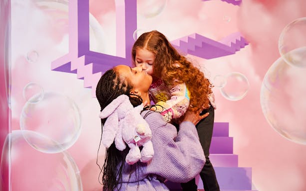 Mother and child embrace at Bubble Planet exhibit, Washington DC.