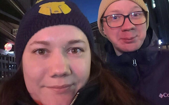 Two people enjoying the Helsinki Murder Mystery self-guided city exploration game at night.