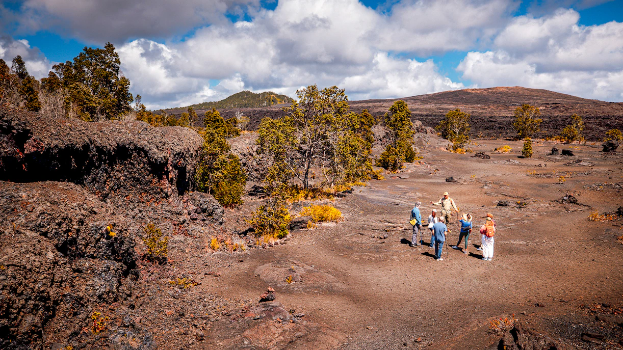 Group exploring volcanic landscape on Hawaii adventure tour.