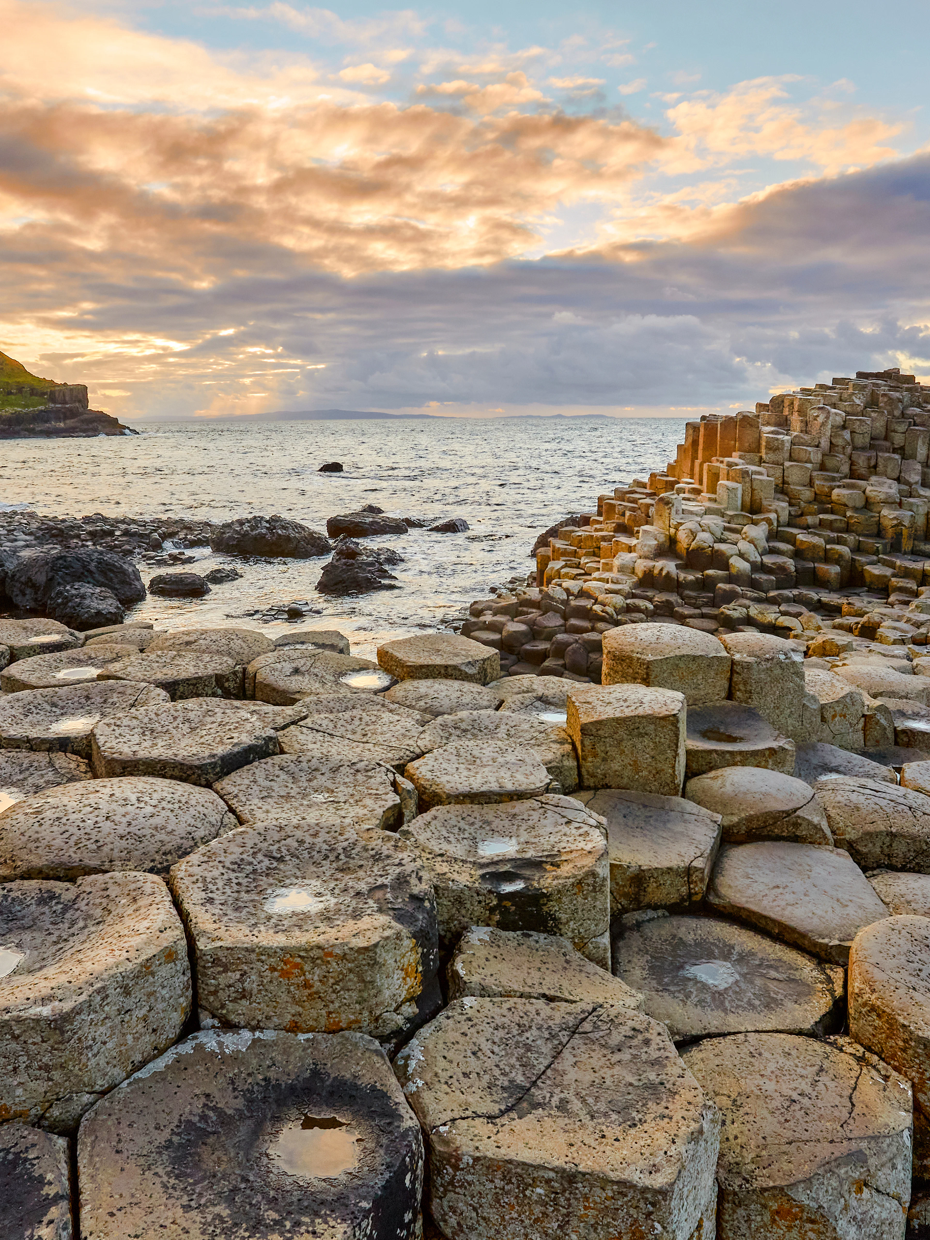 Giant's Causeway basalt columns by the sea at sunset, Northern Ireland.