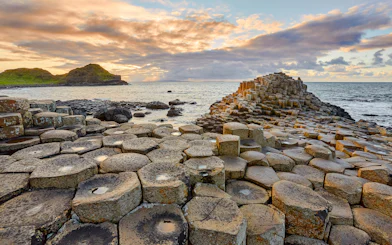 Giant's Causeway basalt columns by the sea at sunset, Northern Ireland.