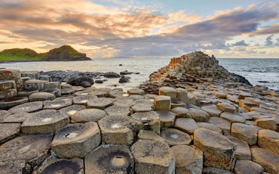 Giant's Causeway basalt columns by the sea at sunset, Northern Ireland.
