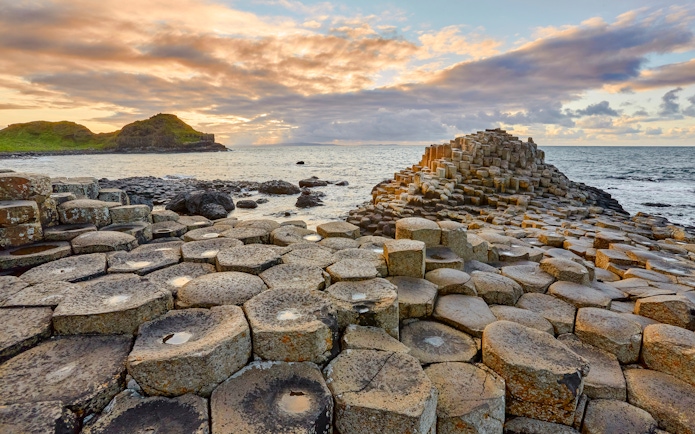 Giant's Causeway basalt columns by the sea at sunset, Northern Ireland.