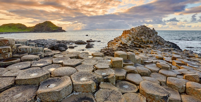 Giant's Causeway basalt columns by the sea at sunset, Northern Ireland.