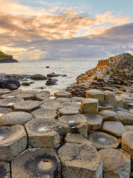 Giant's Causeway basalt columns by the sea at sunset, Northern Ireland.