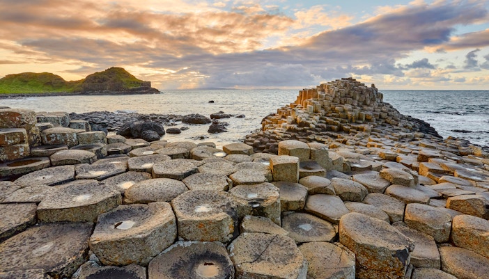 Giant's Causeway basalt columns by the sea at sunset, Northern Ireland.